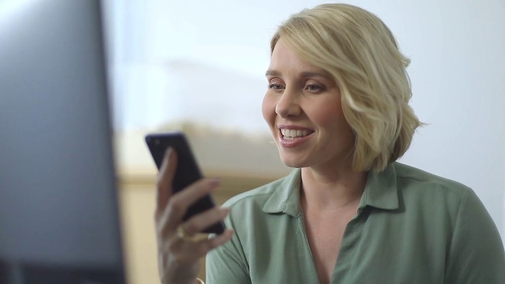 A blonde woman gives instructions to her voice assistants